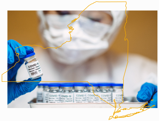 Masked healthcare worker with tray of vaccines